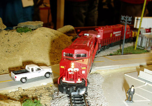Bright red Canadian Pacific train at road crossing