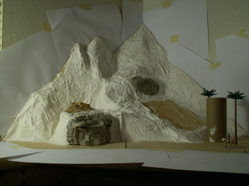 Paper towels dipped in plaster and draped over a cardboard frame.