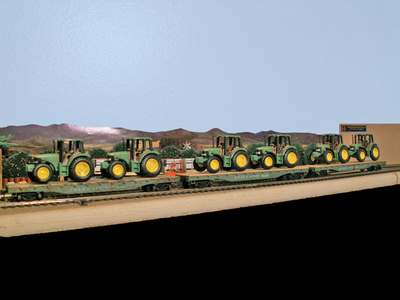 Santa Fe flat cars loaded with John Deer tractors