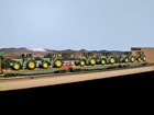 Santa Fe flat cars loaded with John Der tractors