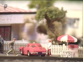 A dad hurries out to his vintage corvette as his daughter waits impatiently