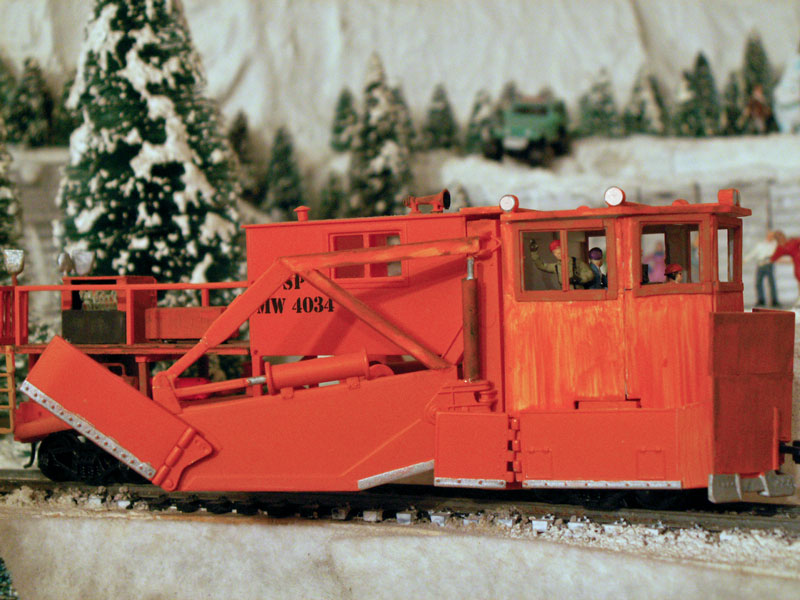 The snowfighting crew inside of the Jordan Spreader raise the plow blades 
