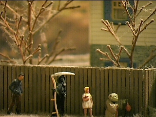 A father follows his children as they trick or treat