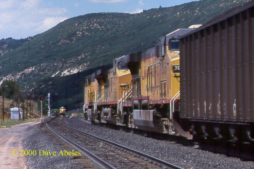 A westbound UP loaded coal drag (at right) meets eastbound             Utah Railway empties with UP power; Soldier Summit, UT                 08/19/00